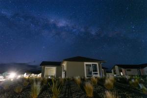 a house at night with the milky way at Snowflake Tekapo in Lake Tekapo