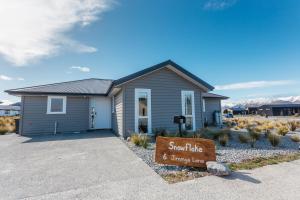 a small house with a sign in front of it at Snowflake Tekapo in Lake Tekapo
