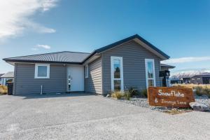 a house with a sign in front of it at Snowflake Tekapo in Lake Tekapo