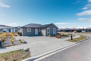 a house in a subdivision with a driveway at Snowflake Tekapo in Lake Tekapo