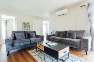 a living room with two couches and a coffee table at Snowflake Tekapo in Lake Tekapo +40 photos