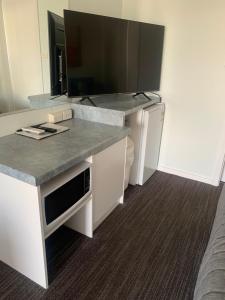 a kitchen with a counter with a sink and a toilet at Robetown Motor Inn & Apartments in Robe