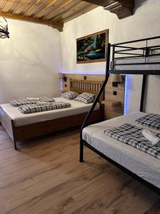 2 łóżka piętrowe w pokoju z drewnianą podłogą w obiekcie HOSTEL LOVELY ROOMS, city center, shared Bathroom, windows to corridor w Villach