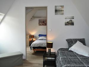a bedroom with a bed and a mirror at Gîte Veigné, 3 pièces, 4 personnes - FR-1-381-102 in Veigné