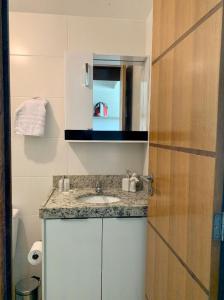 a bathroom with a sink and a mirror at Flat maravilhosa vista beira mar de Intermares 605 in Cabedelo