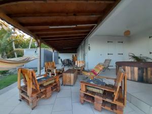 a porch with chairs and a hammock on it at Maison bord de mer à 100 m in Saint-François