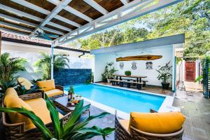 an outdoor patio with a pool and a table and chairs at Casa Tequila in Santa Cruz