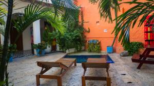 a courtyard with benches and plants in a building at La Puerta Azul in Santa Marta