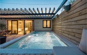 a swimming pool in the backyard of a house at Beautiful Home In Privlaka in Privlaka +15 photos