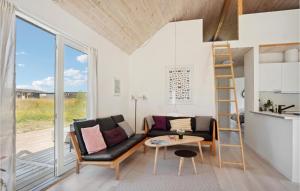 a living room with a couch and a table and a ladder at Nice Home In Sams With Kitchen in Nordby