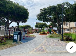a park with a playground and a trash can at La Posada Manabita in Portoviejo