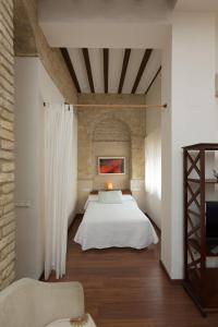 Posteľ alebo postele v izbe v ubytovaní Apartamentos Deluxe Calle Corredera