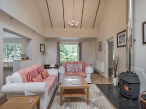 a living room with a couch and a stove at Blackberry Lodge in Ashburton