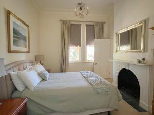 a bedroom with a bed and a fireplace at The Monarch Tumut - Luxury in the valley in Tumut