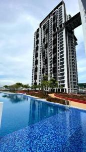 a large apartment building with a large swimming pool at Astetica 3 Bedrooms in Seri Kembangan