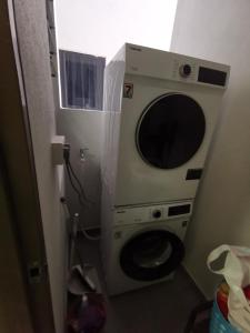 a washer and dryer in a small bathroom at Astetica 3 Bedrooms in Seri Kembangan