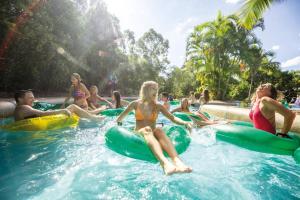 a group of people sitting on rafts in the water at Newly Furnished Spacious 3BR Townhouse at GC in Gold Coast