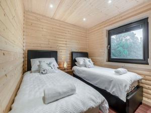 two beds in a small room with a window at Alpaca Lodge in Barkston