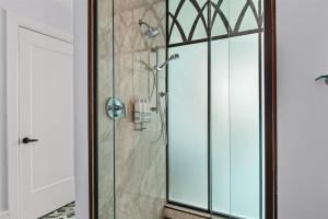 a glass shower stall with a glass door at 'Mountain Gem' A Luxury Downtown Condo with Mountain and City Views at Arras Vacation Rentals in Asheville