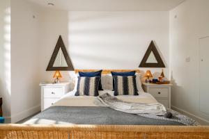 a bedroom with a large bed with two pillows at The Studio in Pevensey