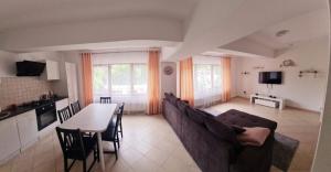 a living room with a couch and a table at apartament BEST VIEW in Buşteni