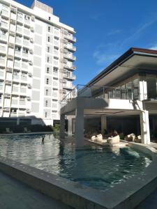 a swimming pool in front of a building at Budget Room in Cebu City