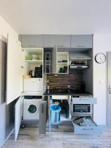 a kitchen with a sink and a washing machine at DnN - Stylish Studio, 2 peoples- WiFi, Netflix, parking - min away to Basel and Airport - dishwasher, washing machine in Saint-Louis