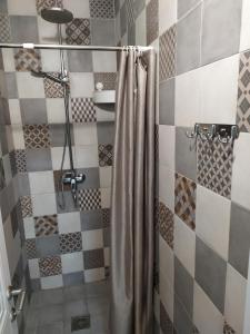 a shower with a shower curtain in a bathroom at Leo in Atyraū +7 photos