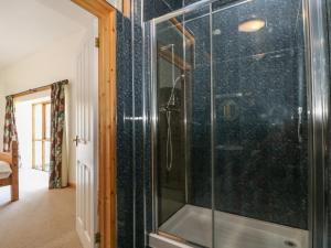 a shower with a glass door in a bathroom at The Shippon in Bude +22 photos