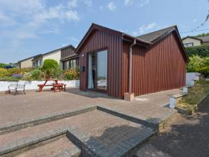 a red building with a patio and a picnic table at SoundView in Plymouth
