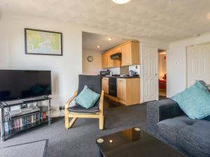 a living room with a couch and a tv at SoundView in Plymouth