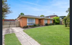 a house with a fence and a grass yard at Cottage with ample outdoor area in Berwick