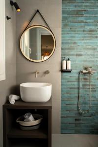a bathroom with a sink and a mirror at Koumbara Sea View in Ios Chora