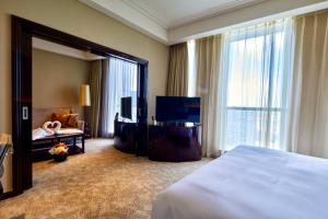 a hotel room with a bed and a large mirror at Renaissance Shanghai Pudong Hotel in Shanghai