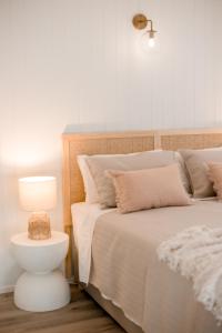 a bedroom with a bed and a night stand with a lamp at Malie - By The Sea in Torquay