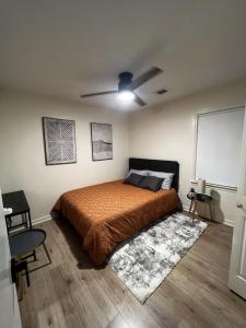 a bedroom with a bed and a ceiling fan at Spacious & Cozy - Close to Fort Moore - Pool Table in Columbus