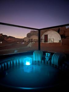 a room with a blue light in the dark at orbit camp 2 in Wadi Rum