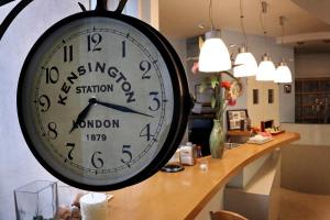 a large clock hanging on the wall in a room at B&B Santiago in Milano Marittima