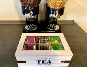 a box of tea sitting on a table with a blender at Sonila's Home in Bergamo