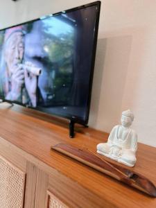 a statue sitting on a table in front of a television at Crystal 7 in Haad Tian