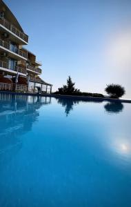 a large swimming pool in front of a building at Villa Lavanda in Vapnyarka