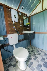 a bathroom with a toilet and a sink at Glamz Hills in Cameron Highlands