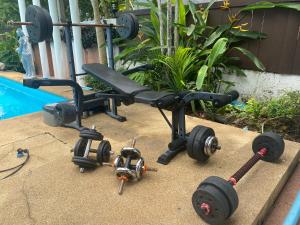a exercise bike with wheels on the ground next to a pool at Phangan Paragon Resort & Spa by Pure Lifestyle in Haad Chao Phao