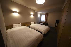 Postel nebo postele na pokoji v ubytování Dormy Inn Express Sendai Hirose Dori