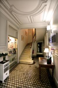 a hallway with a staircase and a stair case at Hotel Henri IV in Coutras