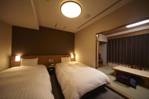 Postel nebo postele na pokoji v ubytování Dormy Inn Express Sendai Hirose Dori
