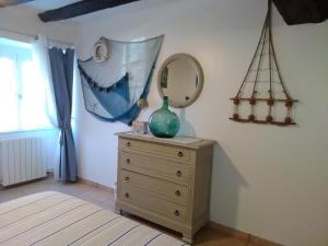 a bedroom with a dresser with a mirror on it at Maison d'hôtes de charme ttakoinenborda in Sare