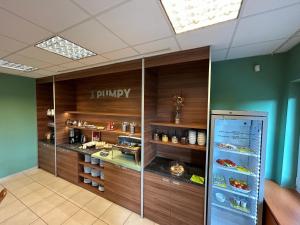a restaurant with a display case with food at Penzion Tři pumpy in Tři Studně