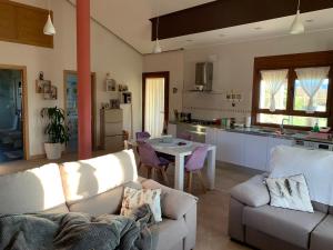 een woonkamer met een bank en een tafel in een keuken bij Acogedora casa de campo,muy cómoda in Ourense