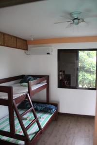 Zimmer mit 2 Etagenbetten und einem Spiegel in der Unterkunft Good Guys Beach Resort in Botolan